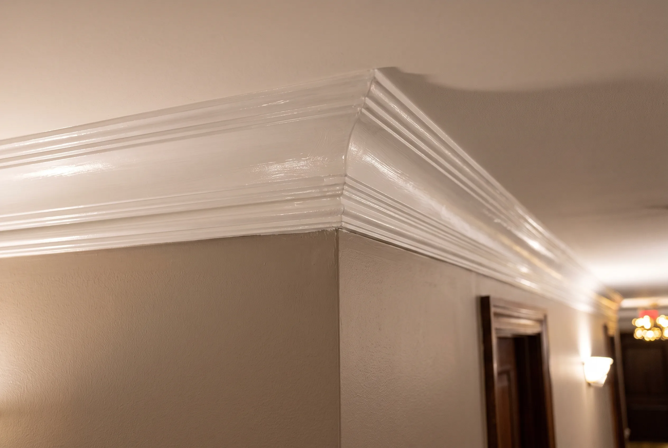 Close-up of freshly painted crown molding in a condominium hallway