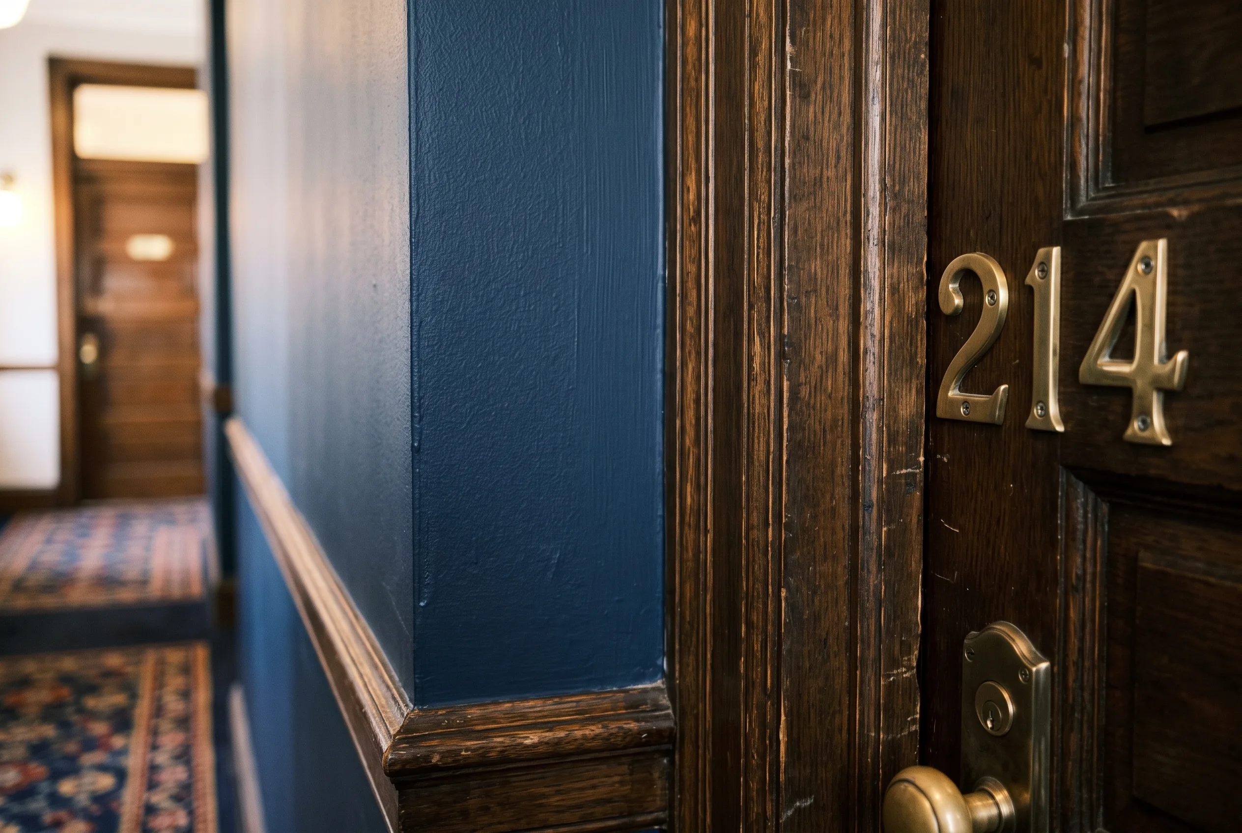 Freshly painted hotel corridor wall next to a guest room door