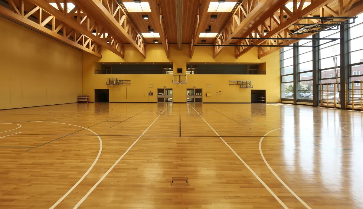 Indoor gymnasium with a wood basketball court