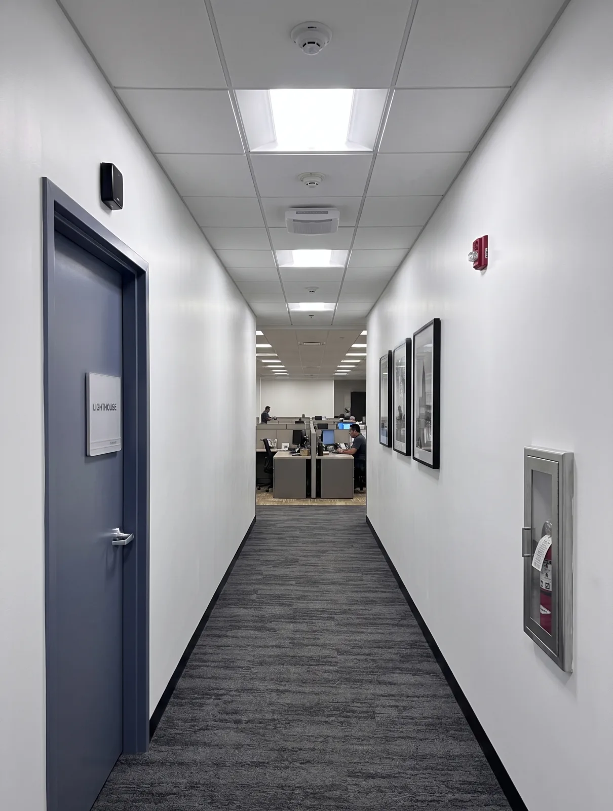 Freshly painted office corridor with framed art in a commercial building