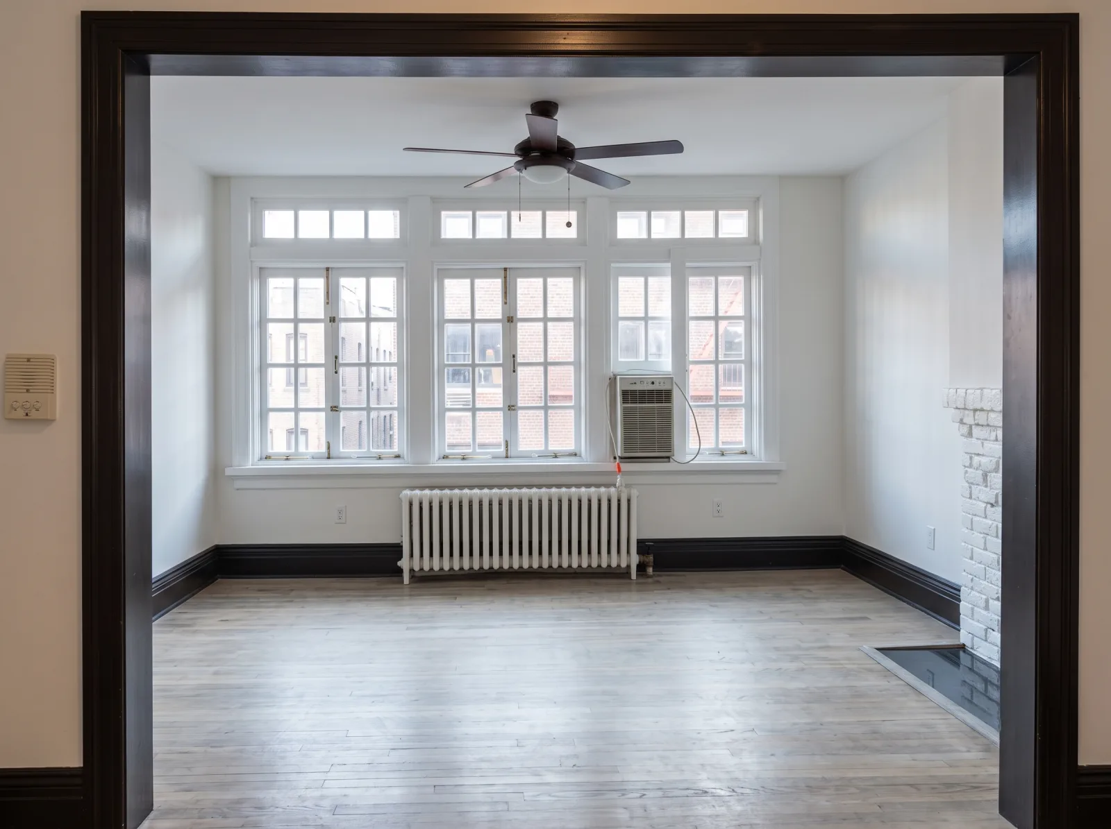 Repainted living room with fireplace in a prewar Manhattan apartment