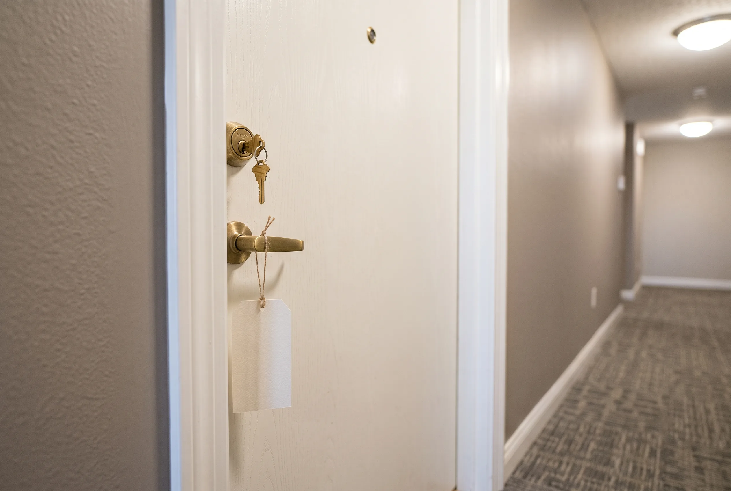 Apartment door with a key and move-in ready tag
