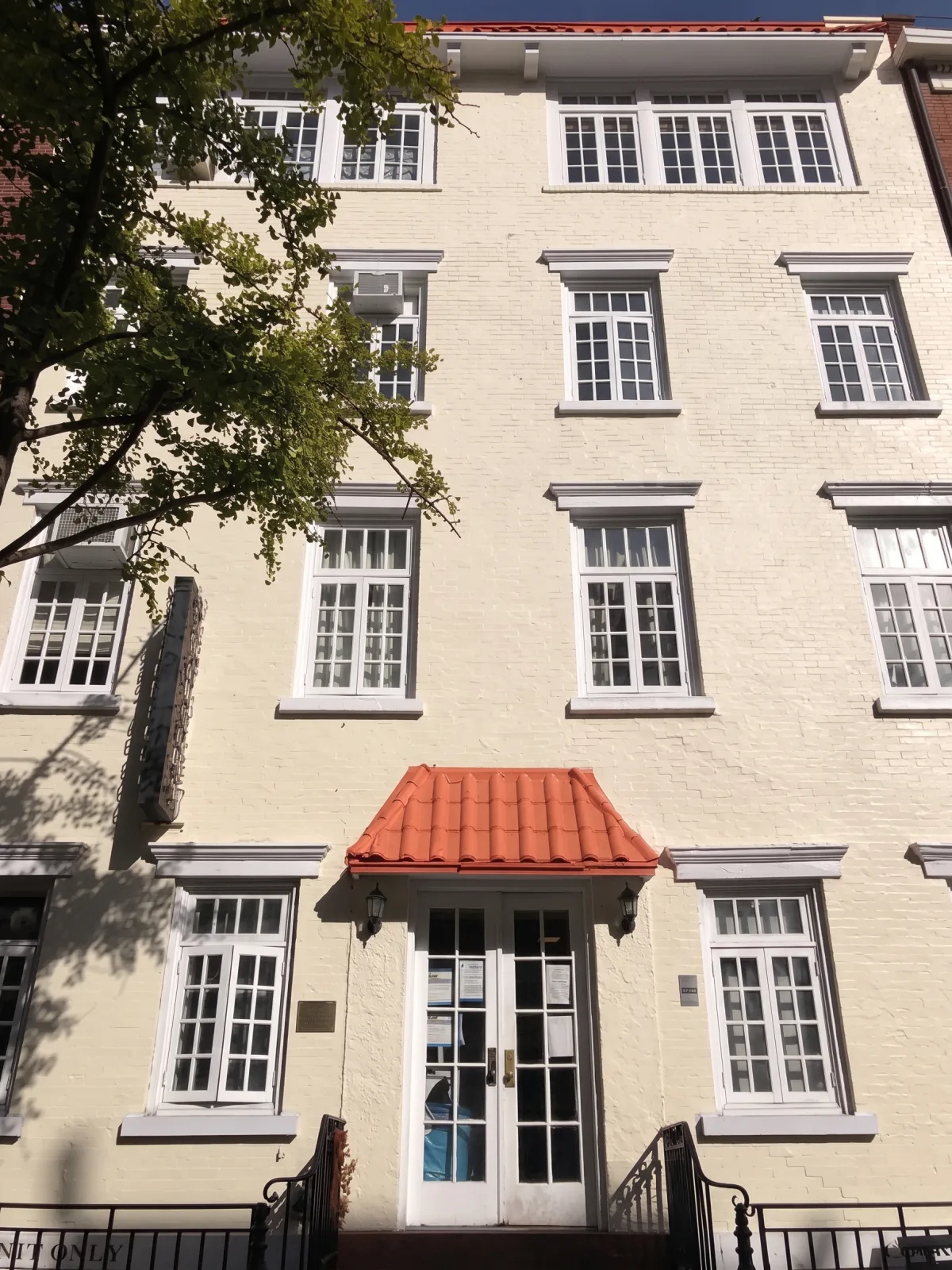 Freshly painted cream brick apartment building facade in NYC