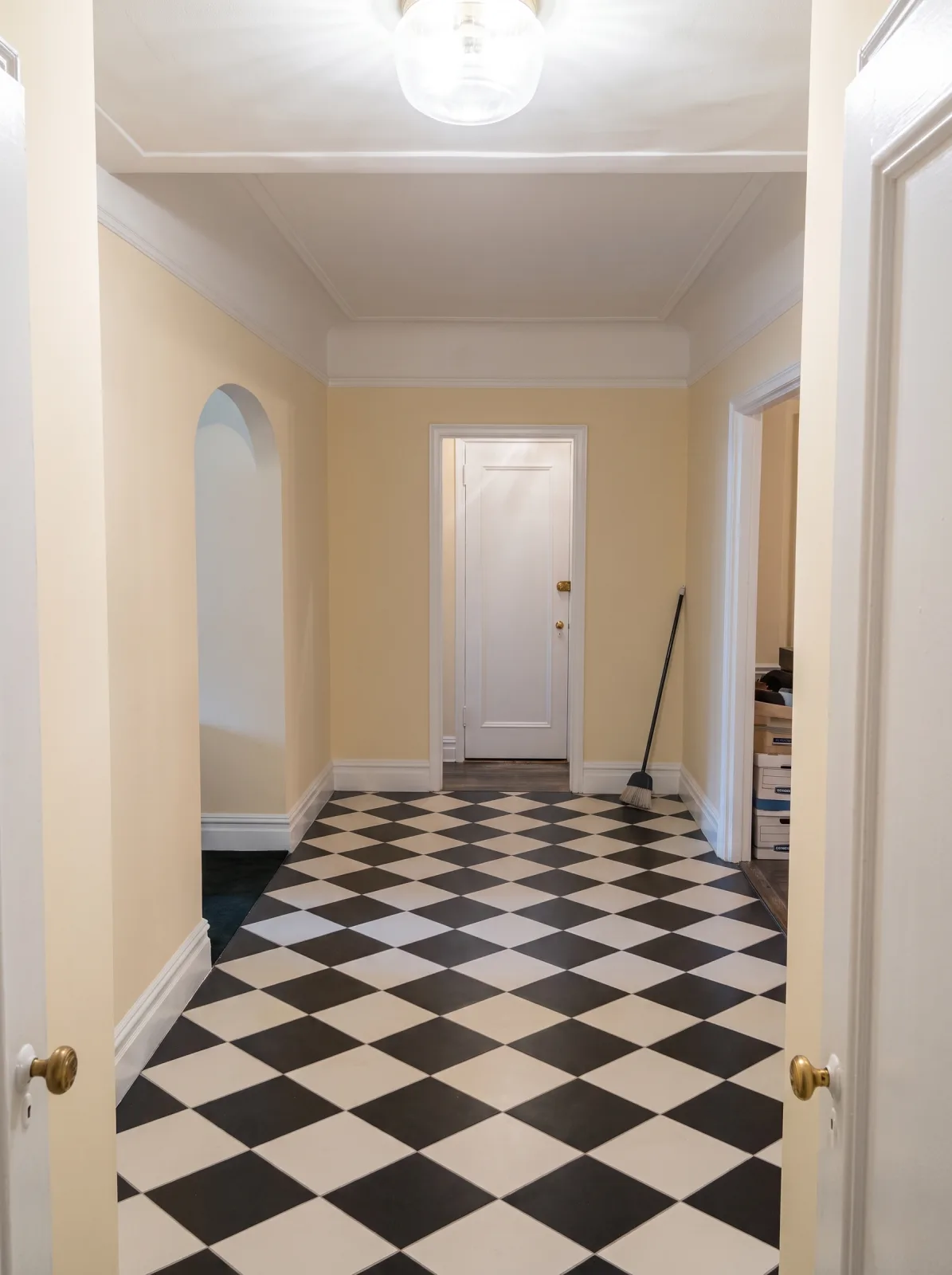 NYC apartment hallway repainted from green to warm cream