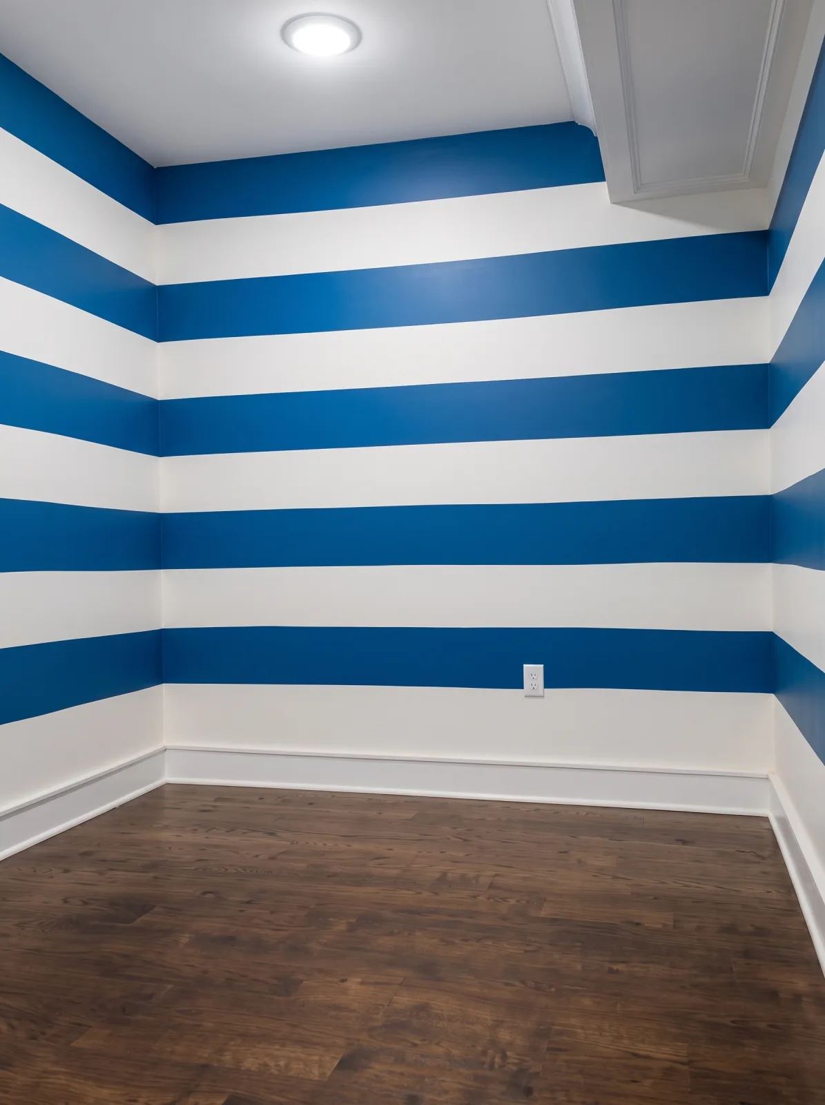 Bold blue and white striped accent wall paint job