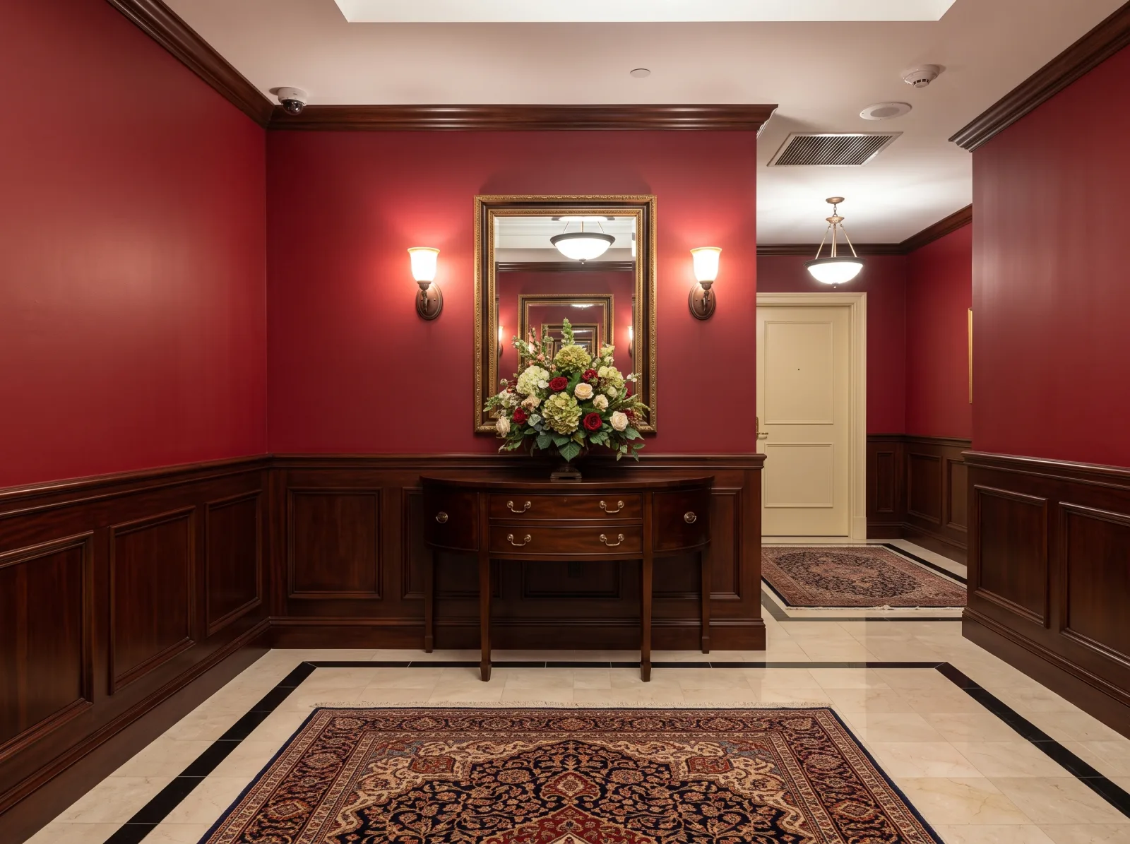 Elegant hallway with dark wood wainscoting and deep red painted upper walls