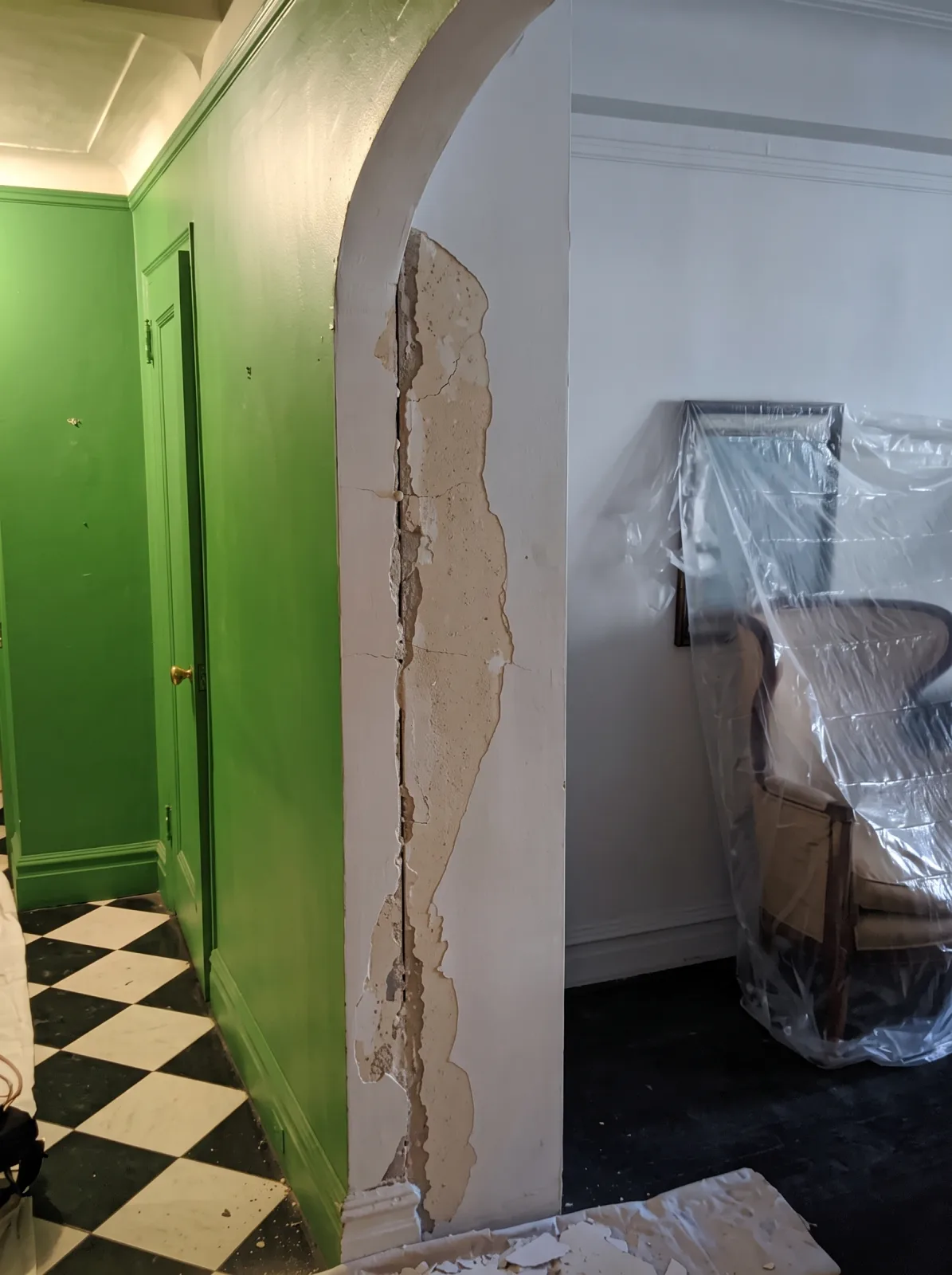 Exposed plaster crack repair next to a freshly painted wall