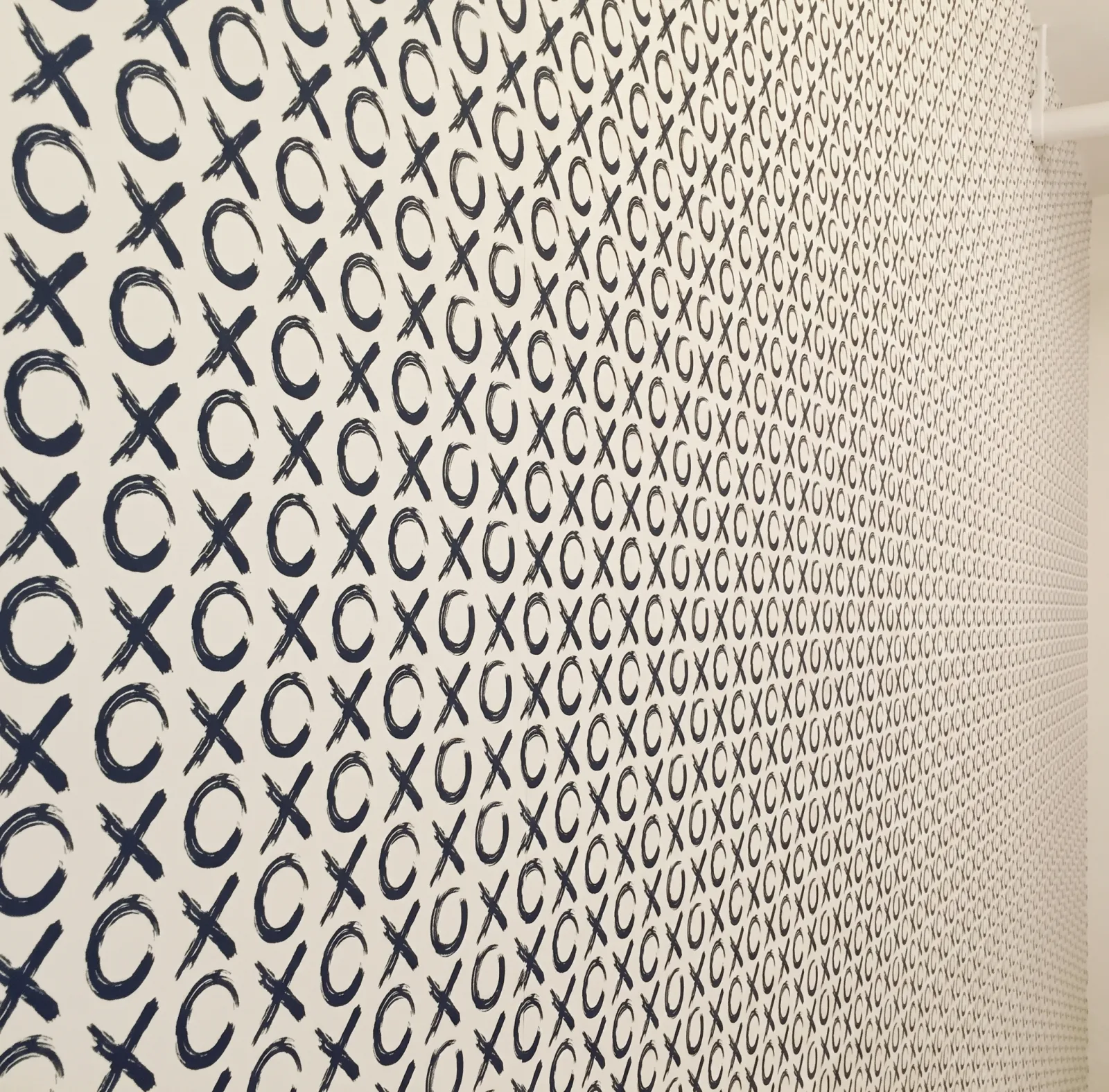 XO-patterned wallpaper wall in a kid's room