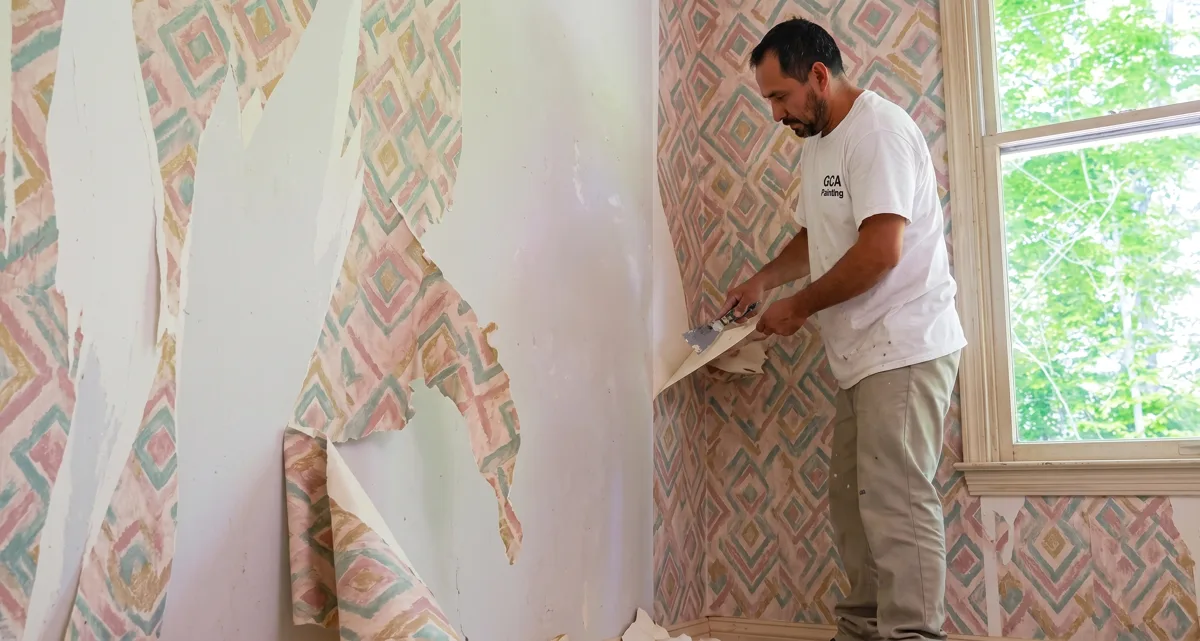 GCA Painting crew removing old wallpaper from a wall
